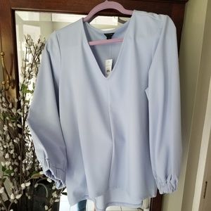 Baby blue v neck blouse.